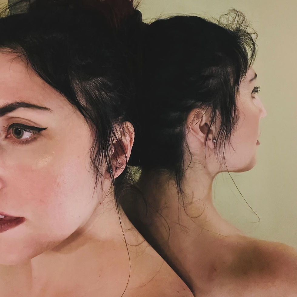a woman standing back to a mirror creating a double image