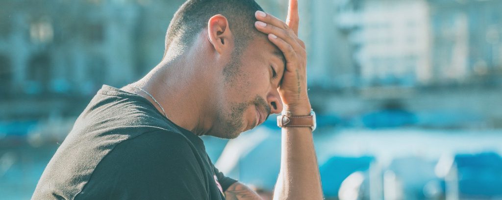 image of man with head in his hand