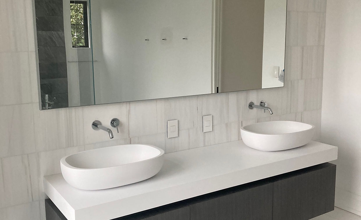 Modern double vanity with white vessel sinks and large mirror