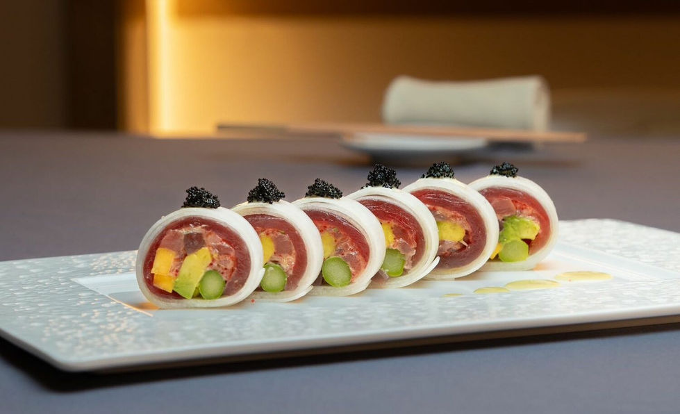 The delectable Kioko roll served at Ushin House is as tasty as it is beautiful. The roll is made from tuna, spicy tuna, mango, asparagus, topped with Alaskan caviar, and a daikon wrapper.
