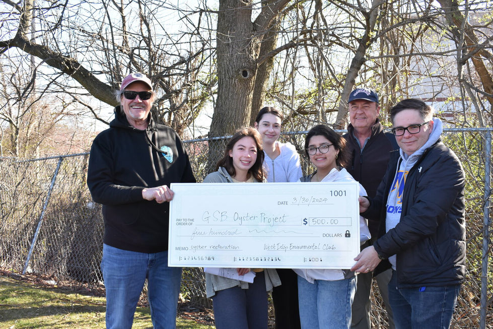 (Pictured left to right) GSB Oyster Project director Andy Mirchel, students of the West Islip Environmental Club, water-quality tester Ed Ragan, and West Islip High School teacher and club director Brian Haldenwang.