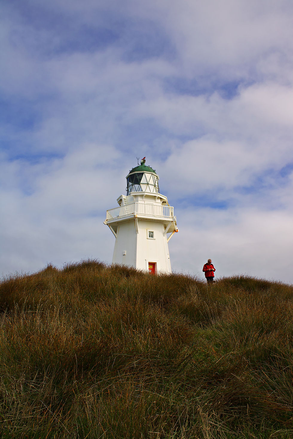 Waipapa lighthouse with man in red in front