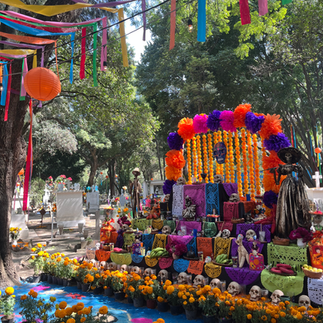 colourful ofrenda within a graveyard