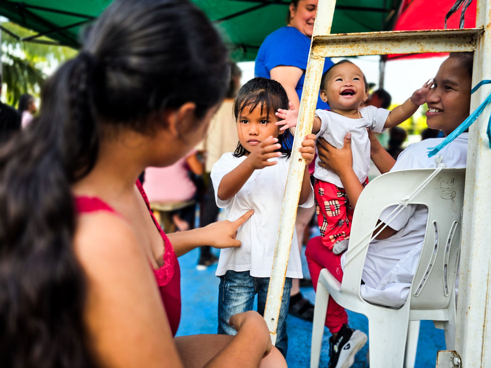 Children playing under a tent at an outdoor event.