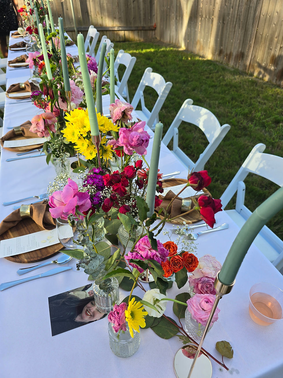 styled party table with candles and colorful flowers