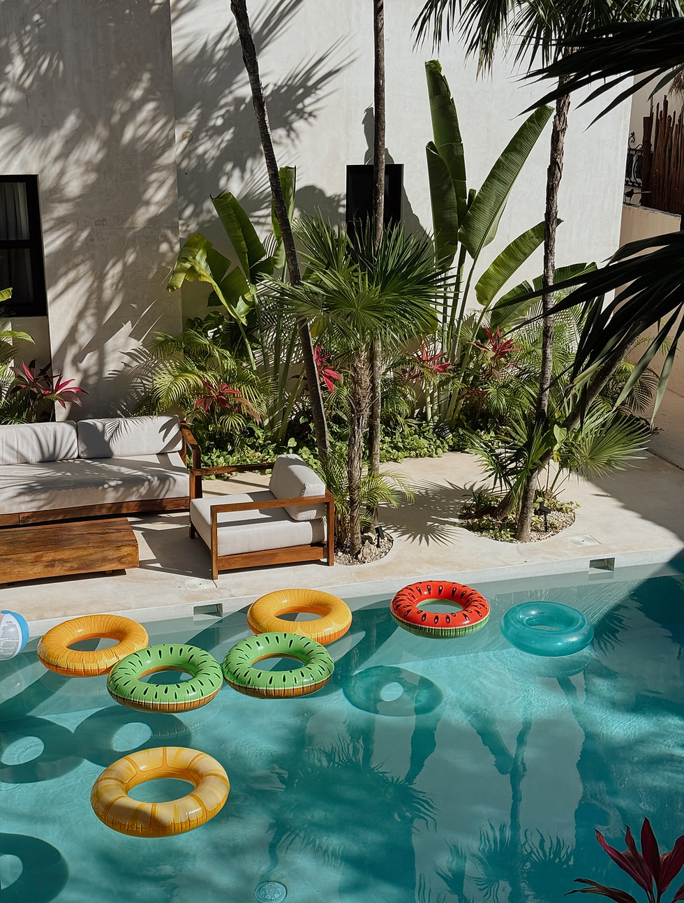 Tropical pool with colorful floaties