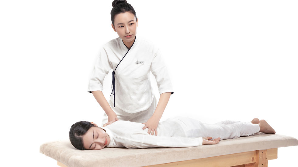 Close-up view of a therapist applying careful pressure to a client’s upper back.