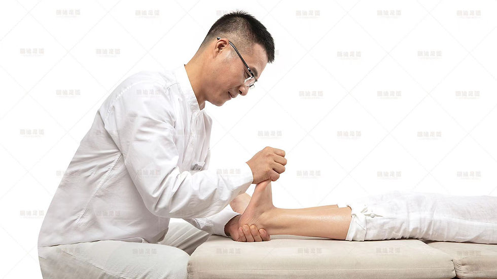 Eye-level view of a foot reflexology therapist applying gentle pressure to a client's foot