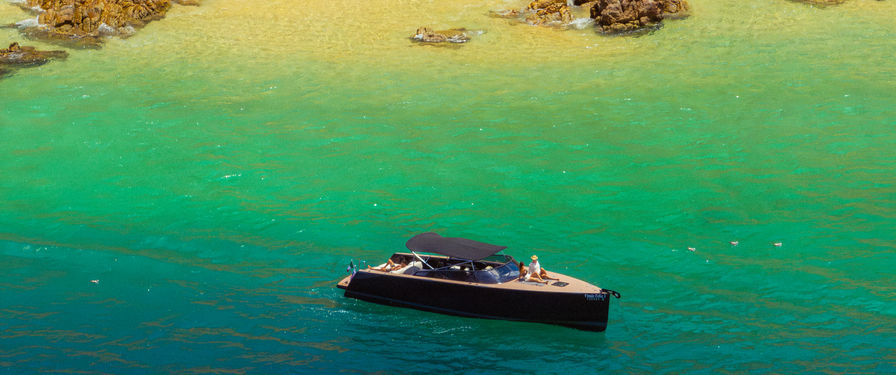 VanDutch 40 yacht charter cruising near the rocky coastline of Los Cabos, Baja California Sur