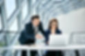 smiling-businesswoman-and-businessman-using-laptop-2024-09-19-11-22-54-utc.jpg