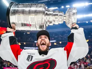 Brandon Bussi hoisting the Stanley Cup after winning the 2026 NHL Stanley Cup with the Carolina Hurricanes 