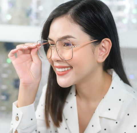 Woman adjusting her glasses