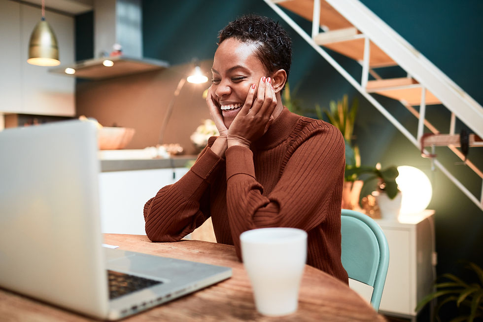 Person smiling at a laptop