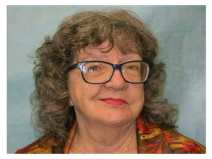 A woman wearing glasses and smiling