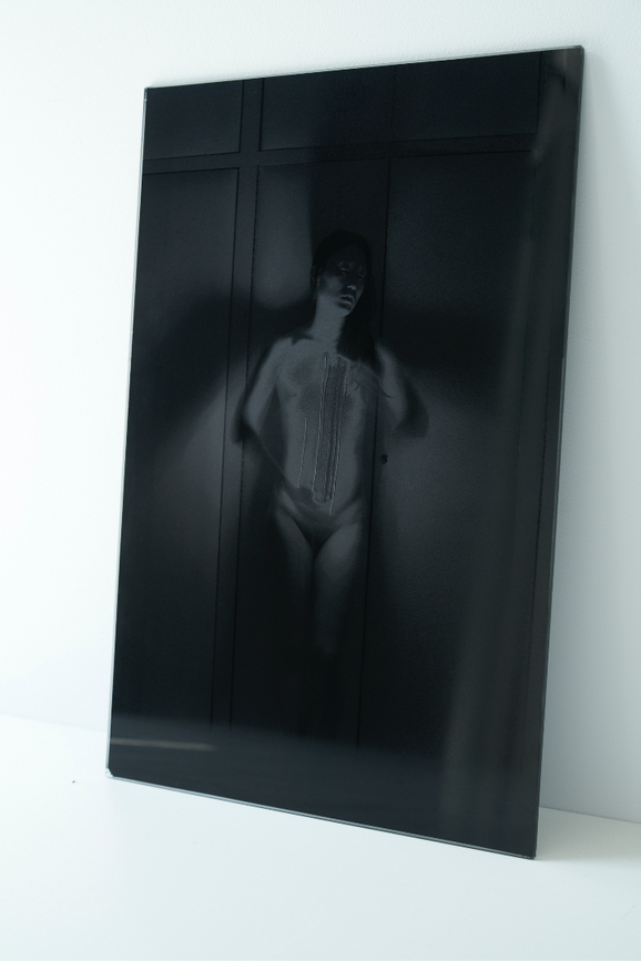 Self-portrait photography. Negative printed on black glass