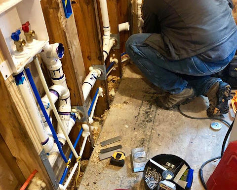 Plumbinator plumber putting in new water pipes for clothes washer in a laundry room renovation