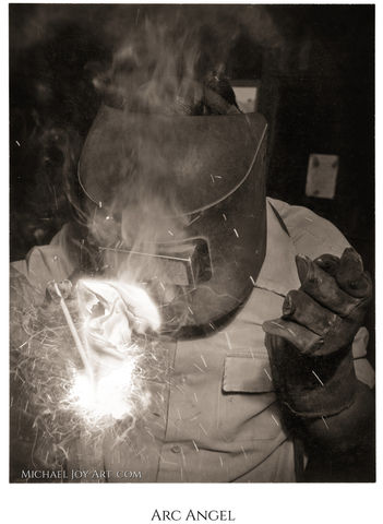 Welder at work, sparks flying, "Mike Awad"