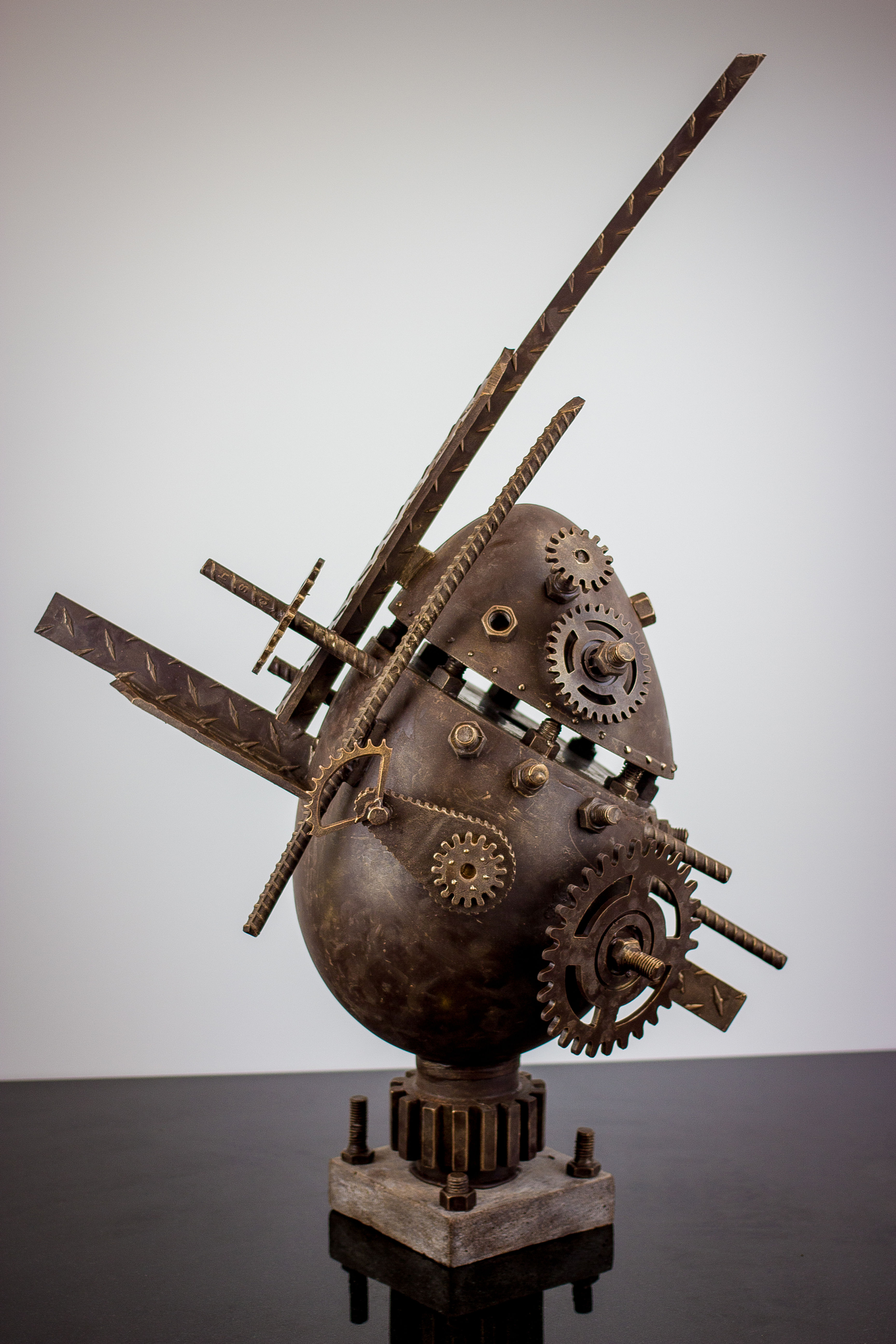 Abstract metal sculpture: gears, rods, egg form