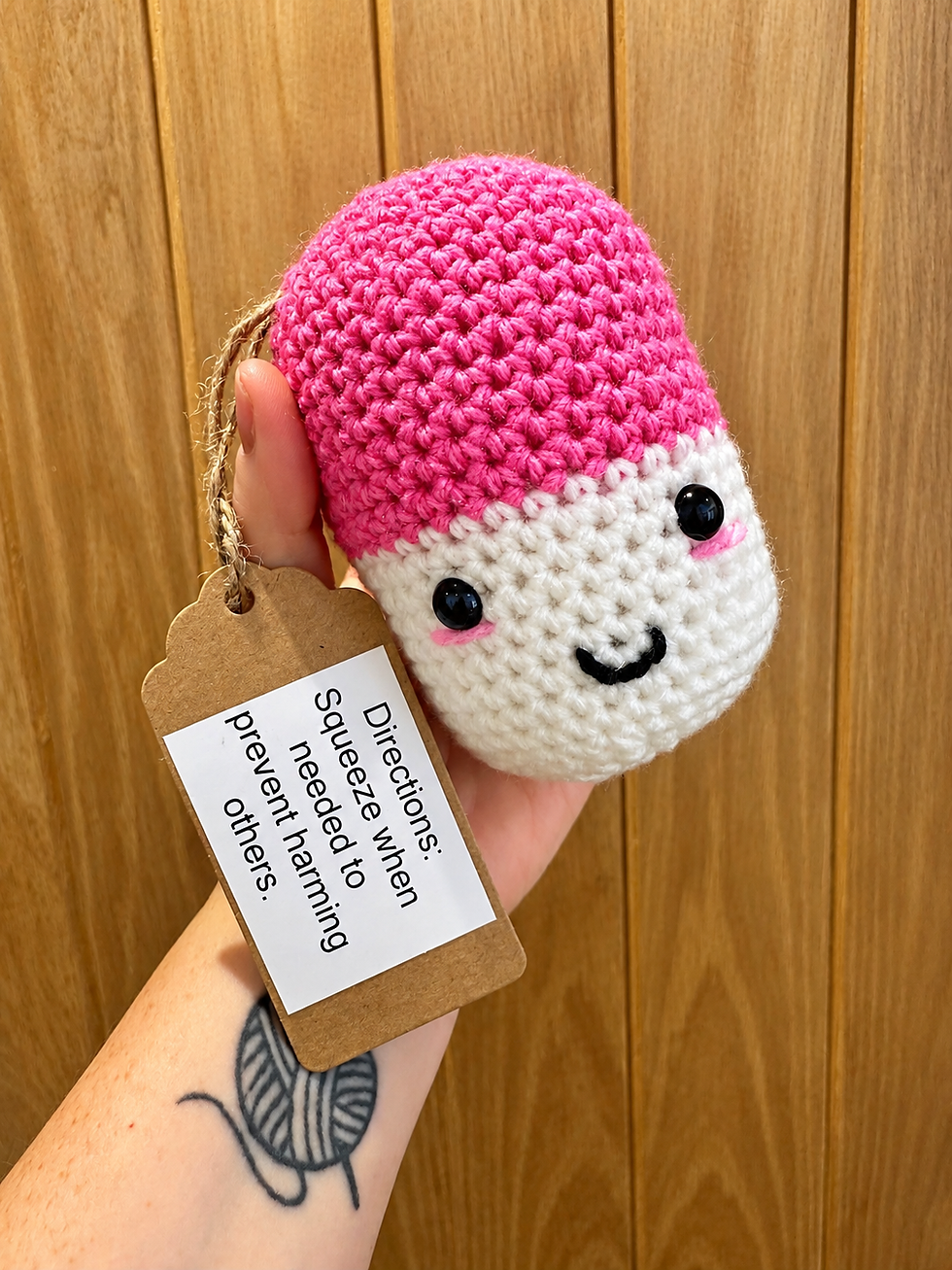 Handmade crochet Chill Pill plush with cute face and colourful top