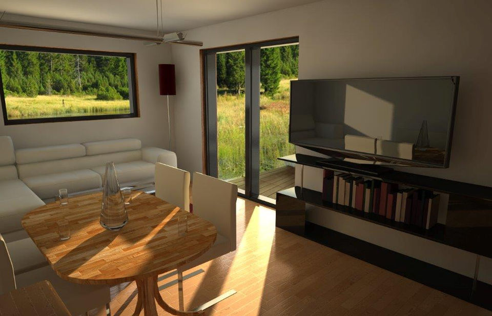 wohnzimmer mit couch, fernseher und esstisch in einem modulhaus