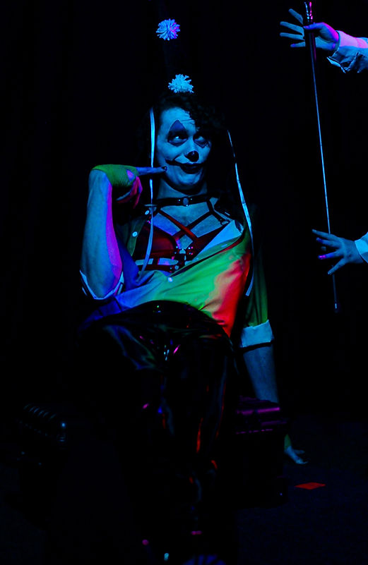 A tall clown being measured during the show