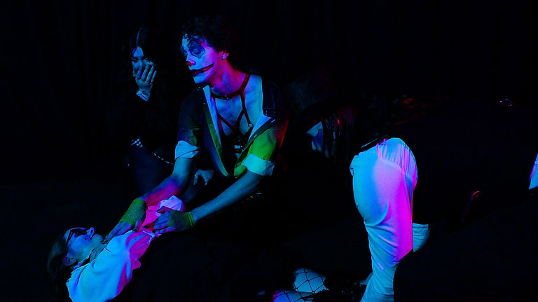 The performer being dragged off by the ringmaster following their fall during the show