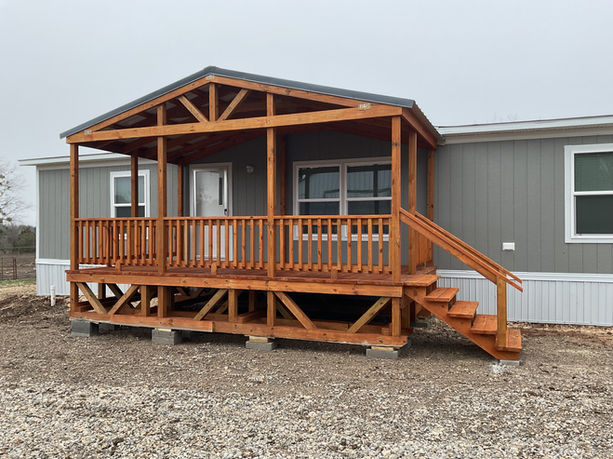 Manufactured home deck with peaked metal roof, treated and stained (with water repellant oil based stain), rail and spindles, 4' wide steps