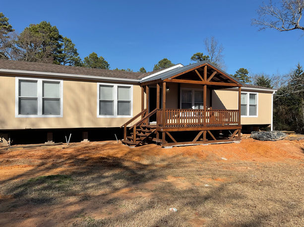Cutom portable mobile home deck, treated wood stained with oil based water resistant stain, with rails and spindles, and 4' wide steps