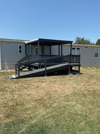 custom mobile home deck with ramp, rails, and steps