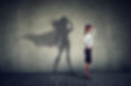 Side view of a business woman imagining to be a super hero looking aspired. .jpg