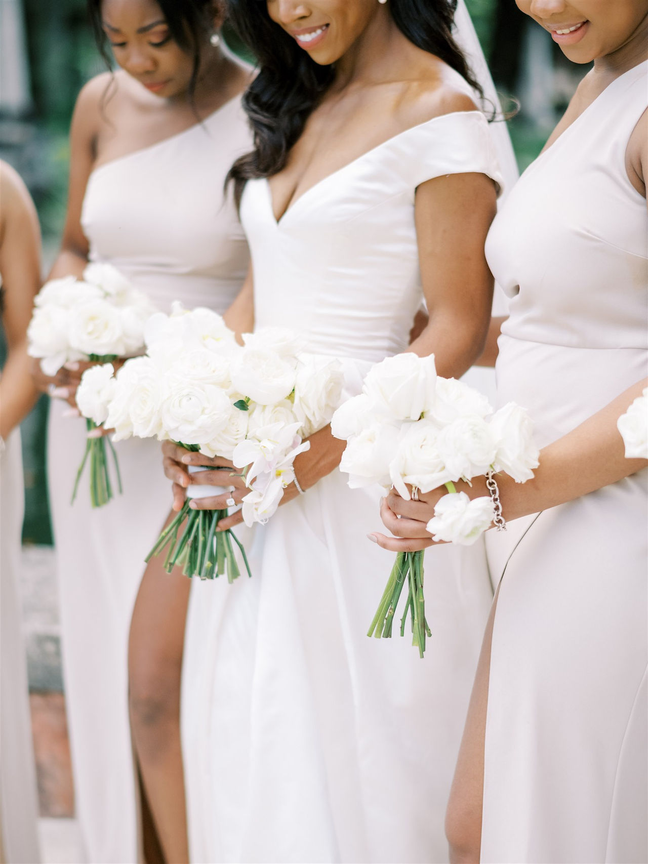 bridesmaids wearing white holding bouquets of white flowers at vizcaya museum and garden