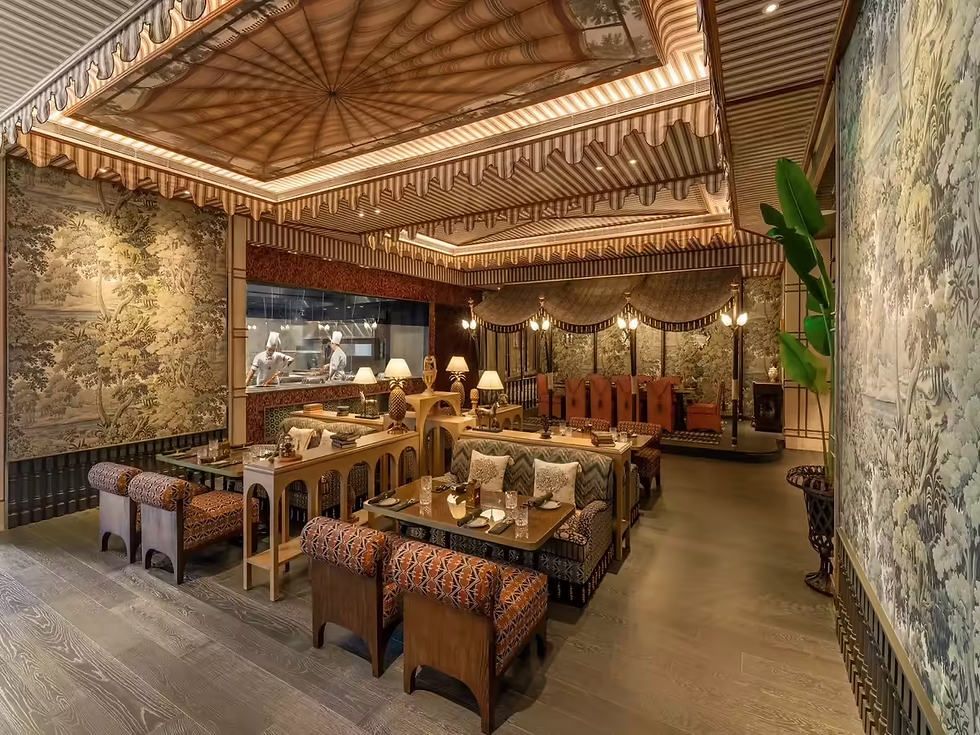 Once you enter the restaurant, the atmosphere is tangible. In your mind, you may have built a picture of the scene with dark wooden floors, cane details, aging brass fittings, retro safari tent details, leafy nooks and crannies, exposed ceiling tenting, and overall colonial themes. It is astonishing how the attention to detail works well here. And to be candid, Rudyard Kipling even has a seat at the bar.