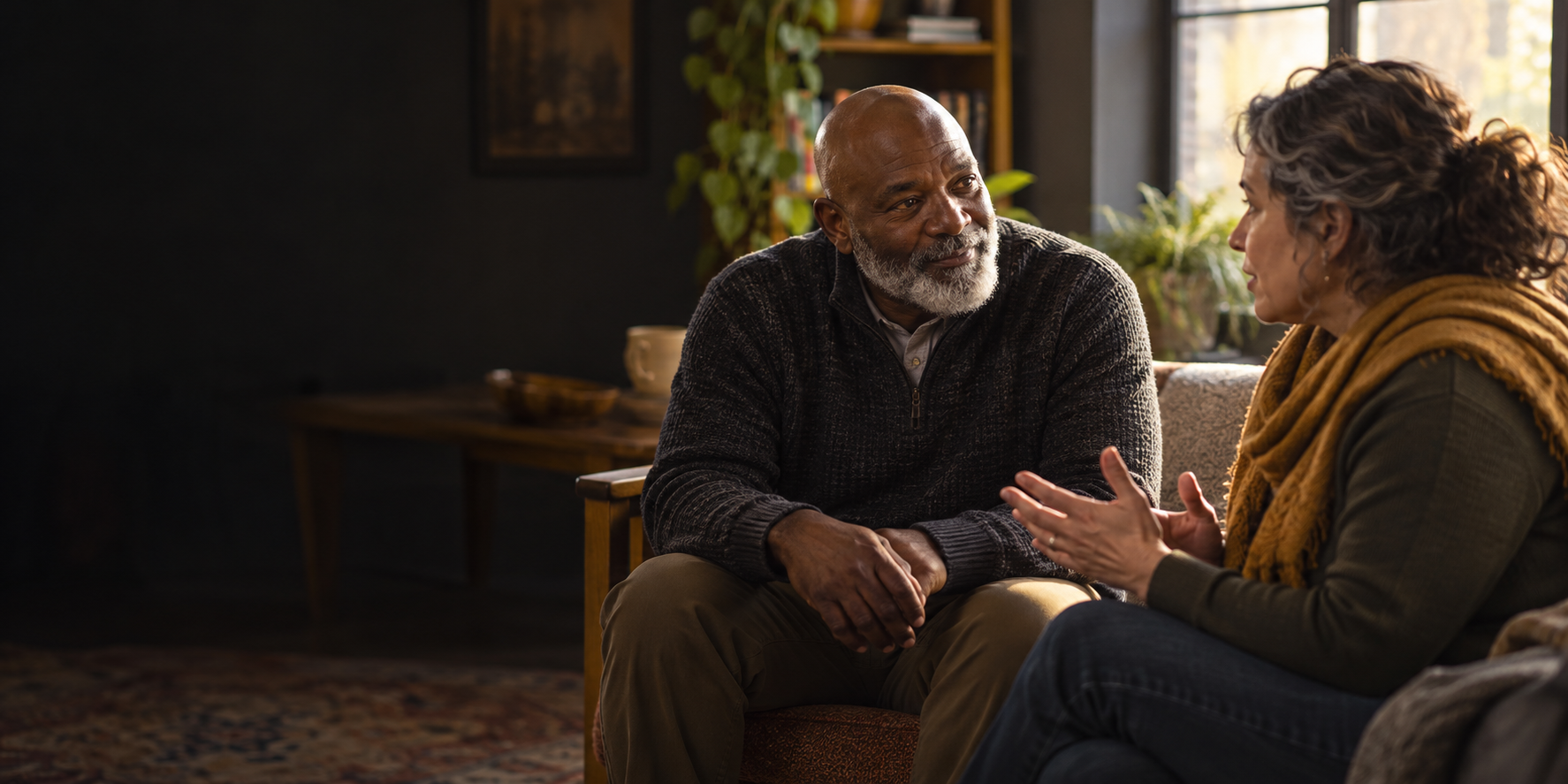 Illustrative scene of two fictional adults sitting together in a thoughtful conversation; not Ignite participants.