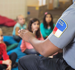 Officer teaching children