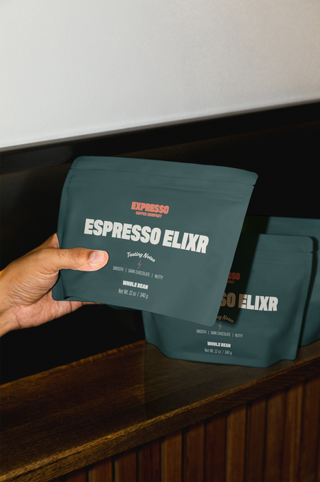 Hand holding Green, Expresso Coffee Bag Packaging showcasing the Expresso brand .