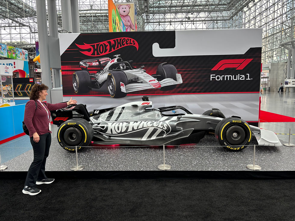 Sue in front of the Formula 1 Hot Wheels display