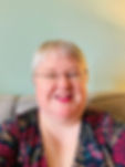 Ruth smiling, she has short grey hair and glasses on.