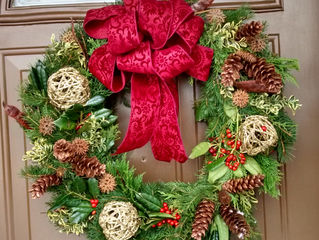 Wreath with fresh holly, boxwood and cones