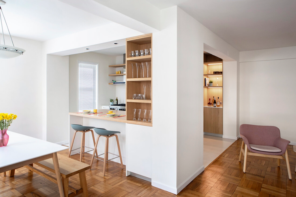 Small Downtown Manhattan kitchen with Italian Cesar cabinetry, compact island, and white lacquer cabinetry. Kitchen cabinetry investment approximately $30K–$35K with total kitchen package costs of $66K–$72K.