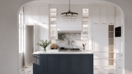 Spacious Hamptons kitchen renovation featuring stacked shaker cabinets to the ceiling, paneled refrigerator, chandelier-lit blue island, quartz countertops, and entertaining-focused open layout with total kitchen package costs from $80K–$91K.