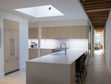Large Soho kitchen renovation featuring integrated appliances, concealed storage, furniture-inspired design, wine cooler integration, and cabinetry costs of approximately $33K–$36K.