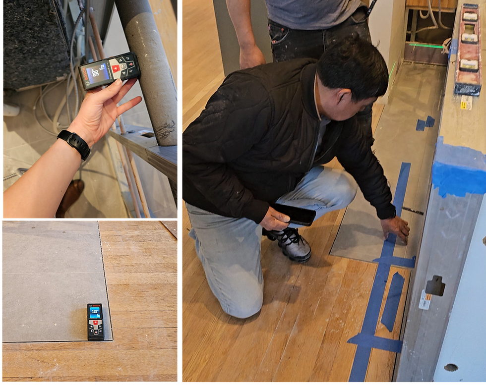 Construction-site photos showing field measurements used to verify a kitchen peninsula layout against coordination drawings, including the tile inlay and plumbing rough-in locations before cabinetry installation