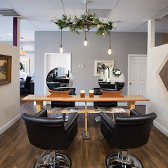 High angle view of a hair salon interior with styling chairs and mirrors