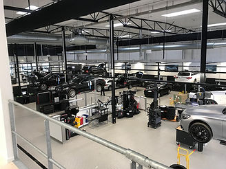 modern vehicle service centre with many luxury vehicles