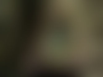 Woman holding up a mirror in the forest