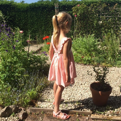 Ruffle back pinafore, pink swiss dot