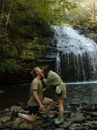 Proposal in front of waterfall