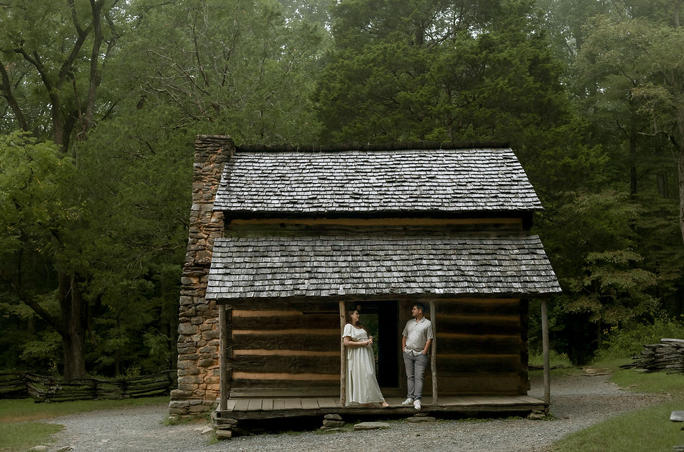 cabin with couple standing on porch