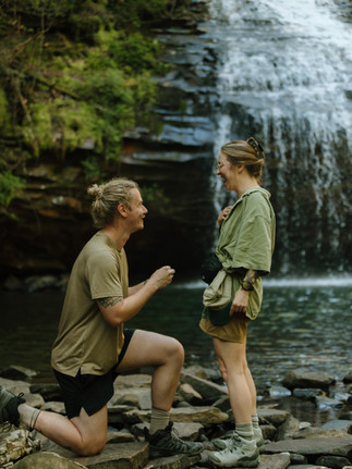 Proposal in front of waterfall