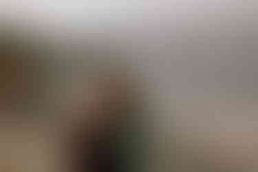 couple cuddling in front of alpine lake